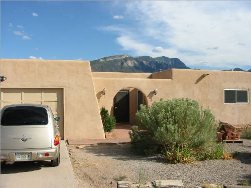 The front of the house with Sandia peak peeking over the roof!