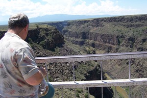 David contemplates a laptop computer at the bottom of the Rio Grand gorge bridge near Taos, NM